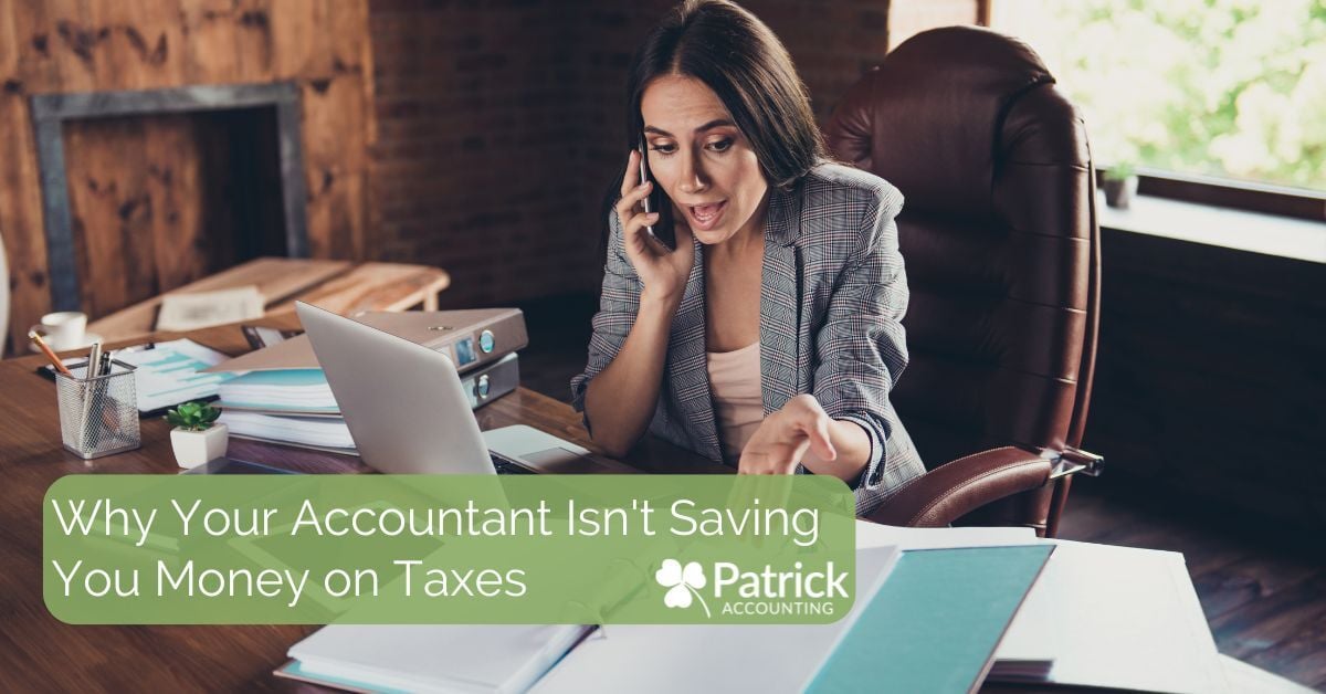 Small business owner frustrated over taxes while talking on the phone with her accountant, highlighting why your accounting firm may not be helping you save money on taxes.
