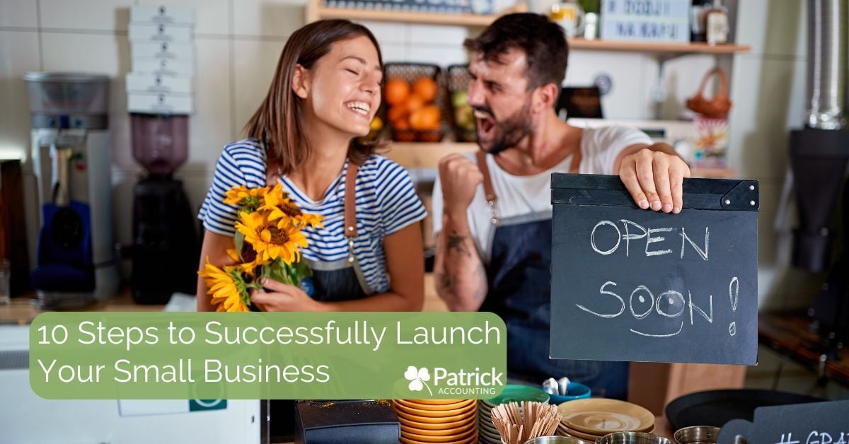 Happy small business owners preparing to open, with one holding sunflowers and the other holding a chalkboard sign that reads