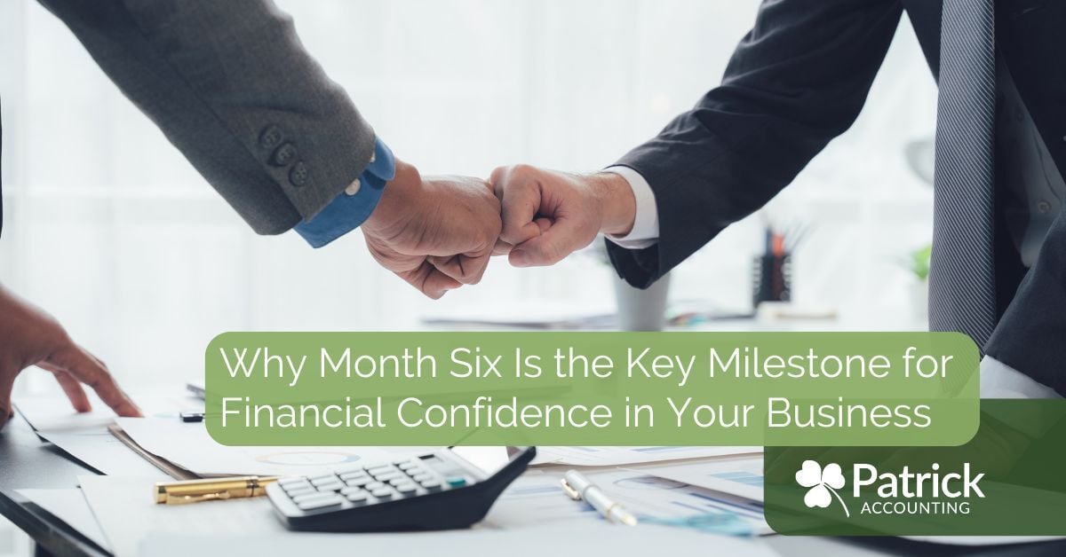 Two business professionals doing a fist bump in an office setting with financial documents on the desk, with the title