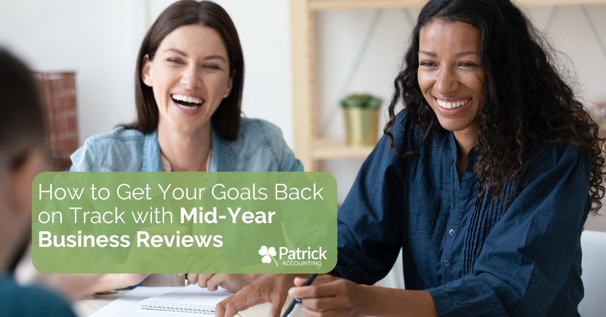 Two smiling businesswomen reviewing documents together with overlay text