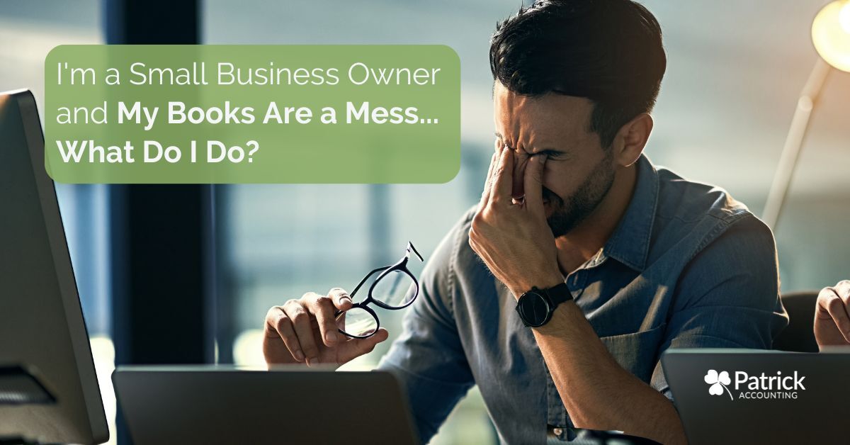 Small business owner reviewing financial records at a computer with a stressed expression, illustrating bookkeeping challenges and messy accounting records for small businesses.