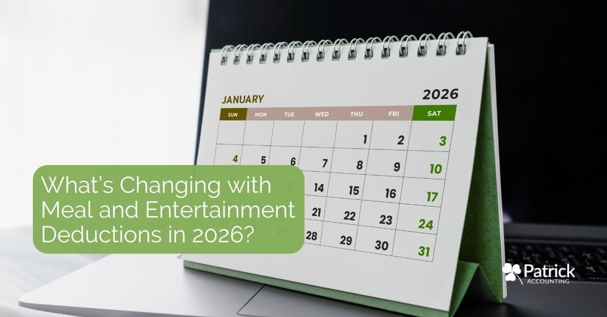 Desktop calendar, sitting on top of a laptop and opened to January 2026, representing upcoming changes to meal and entertainment tax deductions for businesses.