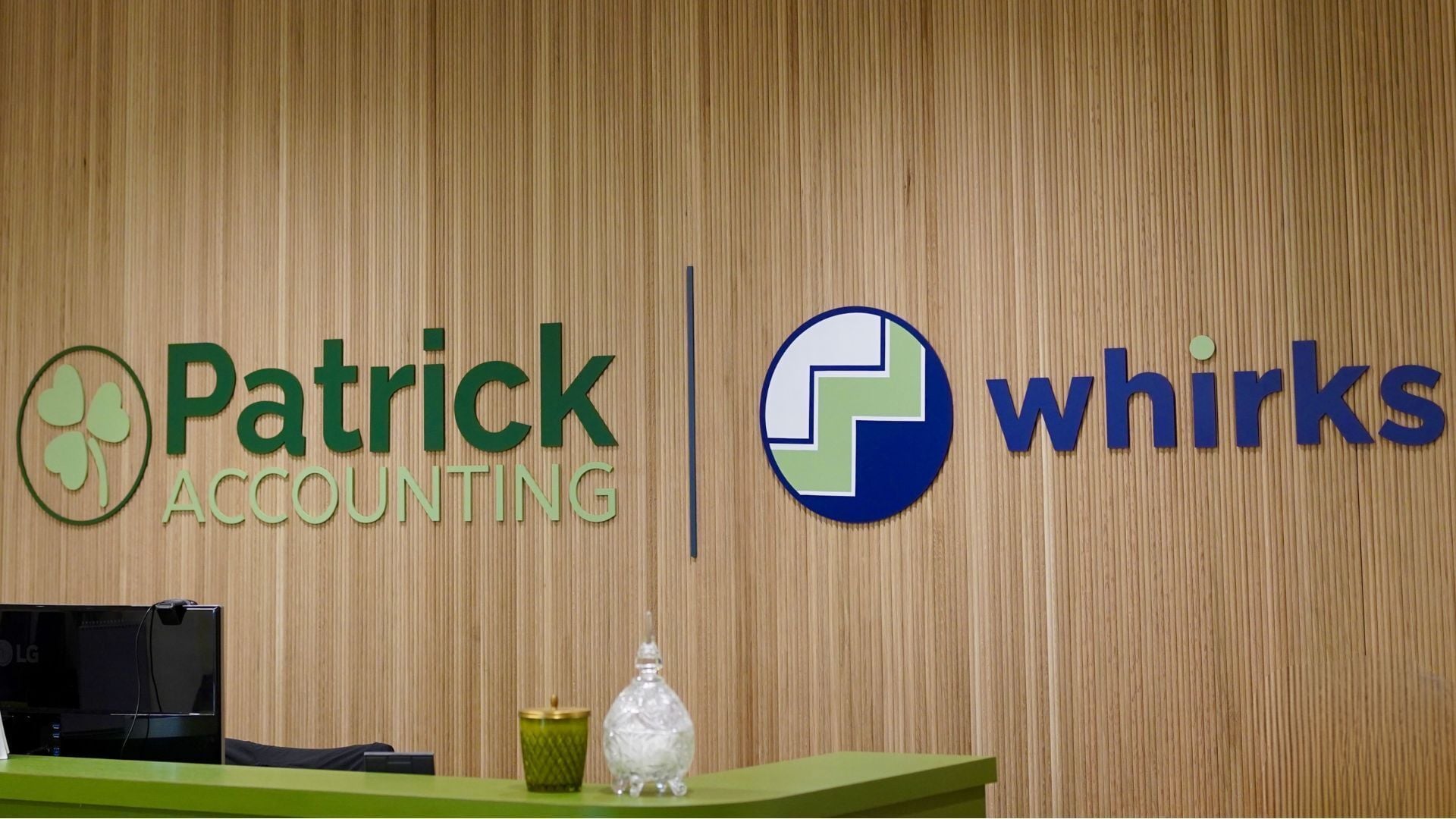 Photo of Patrick Accounting and Whirks new office entry with both logos at the new location at 7345 Goodlett Farms Pkwy in Cordova, Tennessee. 