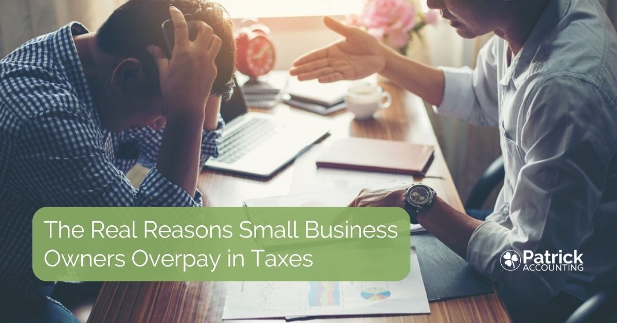 Small business owner leans over desk with his hand in his heads, frustrated because he needs help to keep from overpaying in taxes.