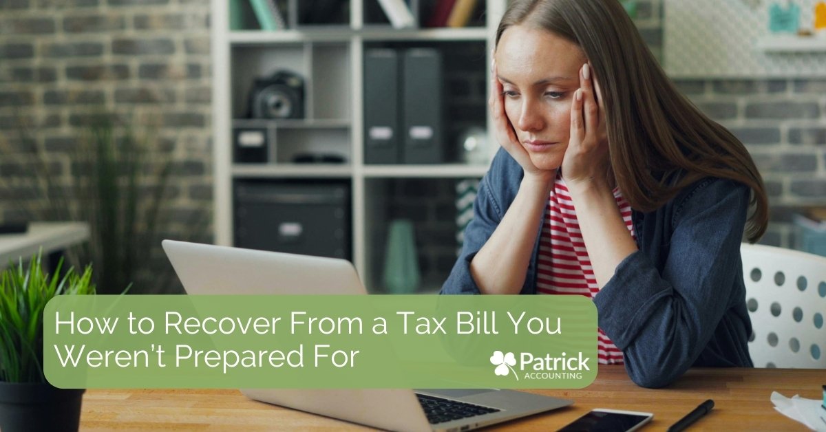 A woman sits at a desk holding her head in her hands while looking at a laptop. Text on the image reads, 
