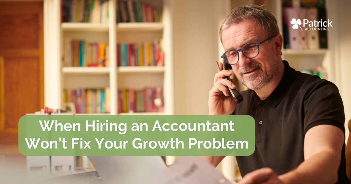 Business owner on phone at desk reviewing documents, highlighting limits of hiring an accountant to solve underlying business growth issues. 