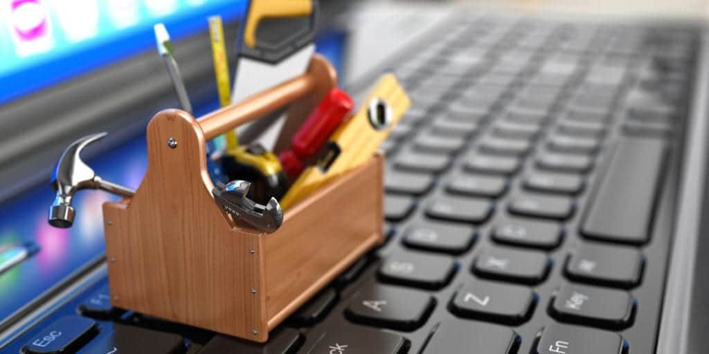 Online support. Toolbox with tools on laptop. 3d